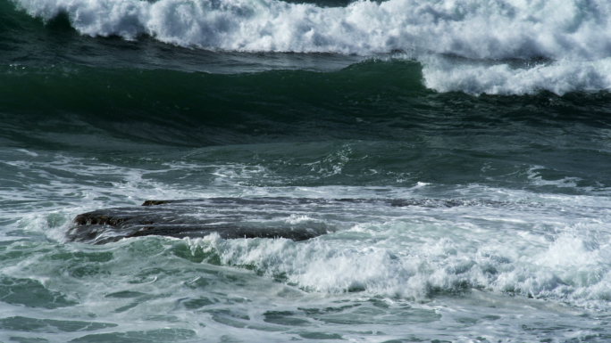 Waves Rolling Over Rocks